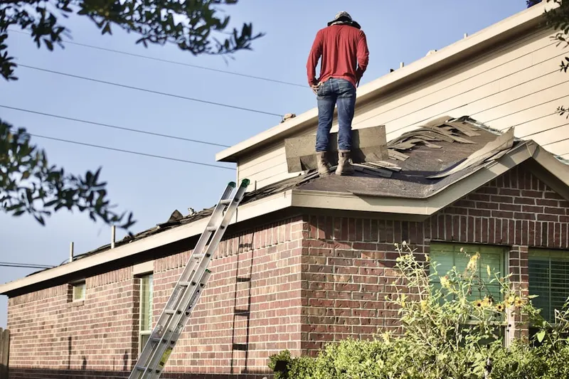 Professional roofer working on a residential roof in Olympia
